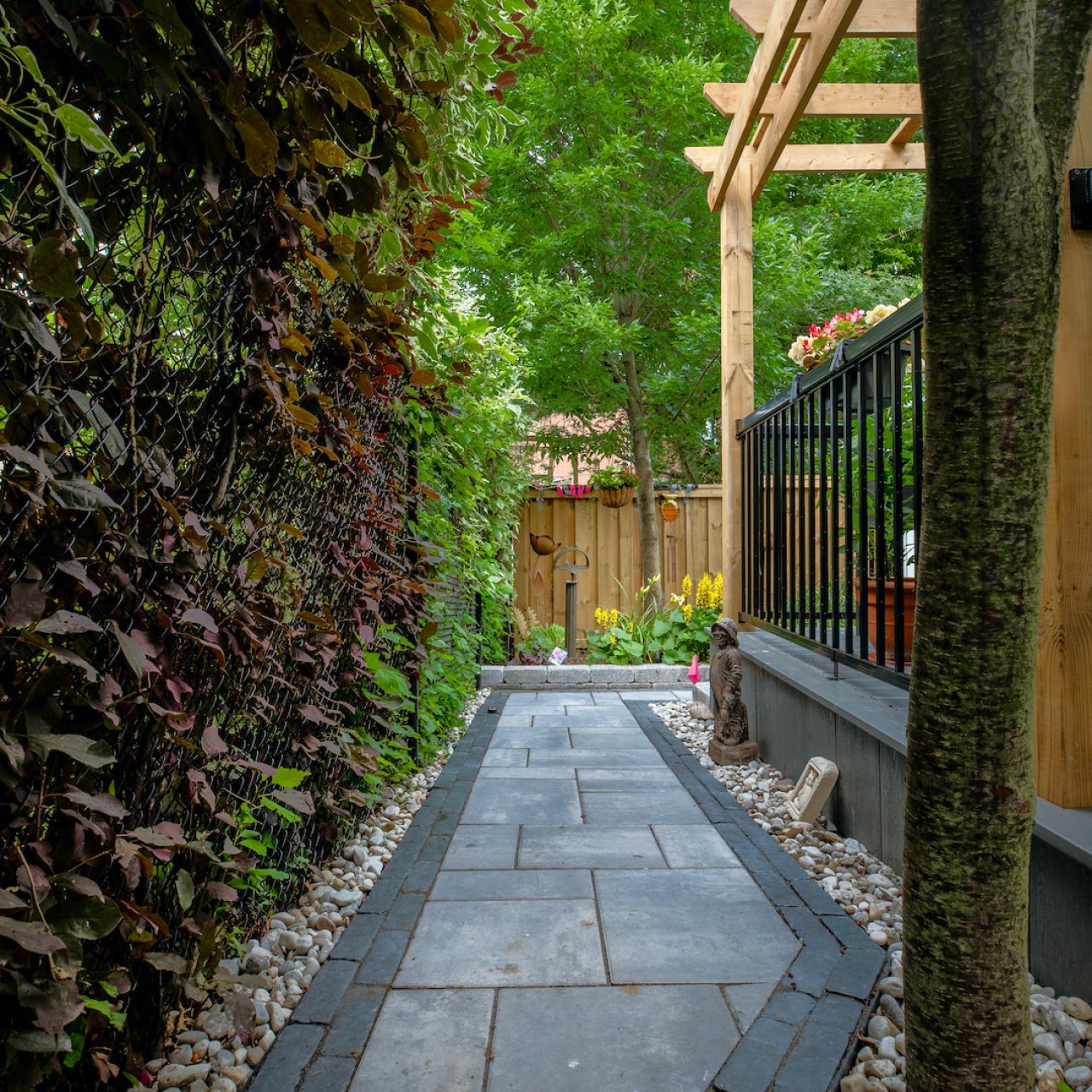 Residential backyard with stone pathway and plants
